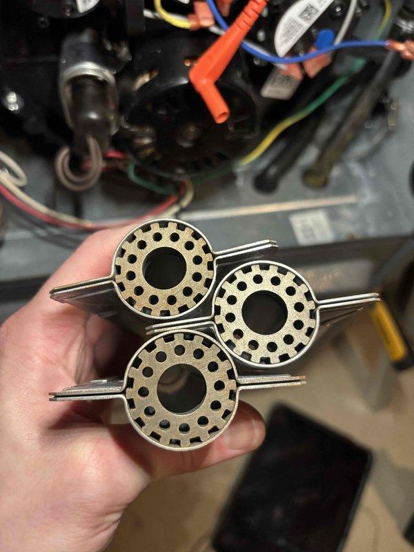 Completed annual heating maintenance on EnergiAir furnace system with warranty coverage through September 2030. Inspected and removed three burner assemblies showing carbon buildup and heat discoloration; cleaned components and verified proper operation of all heating elements, gas valve connections, and electrical wiring before reinstalling and testing system functionality.