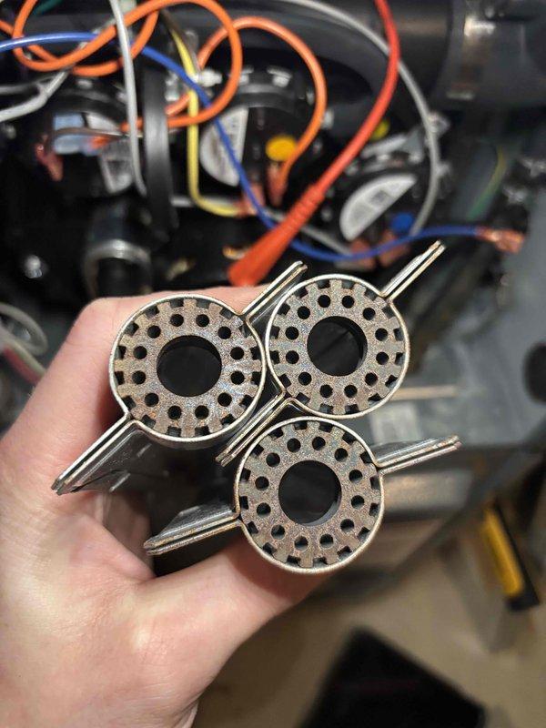 Completed annual heating maintenance on EnergiAir furnace system with warranty coverage through September 2030. Inspected and removed three burner assemblies showing carbon buildup and heat discoloration; cleaned components and verified proper operation of all heating elements, gas valve connections, and electrical wiring before reinstalling and testing system functionality.