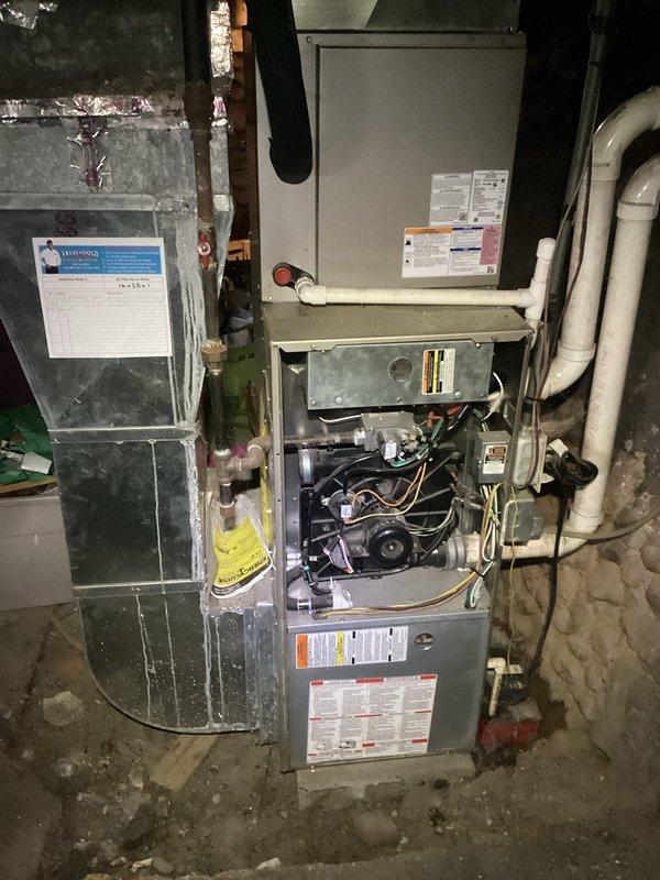 Responded to no heat call on 17-year-old Payne furnace system. Upon arrival, performed diagnostic inspection of unit with access panel removed to assess internal components including blower motor, wiring, and mechanical assemblies. Documented existing equipment configuration including furnace, air handler, ductwork connections, and associated PVC drainage/ventilation piping. Verified unit specifications via manufacturer data plate showing model CNPVP3017ALA4AA with R-410A refrigerant system manufactured February 2019. Conducted thorough visual assessment of HVAC installation in basement utility area, noting age-related wear on ductwork and surrounding components. Photographed equipment labels, safety warnings, and technical specifications for service records. System evaluation completed to determine cause of heating failure and provide recommendations for restoration of proper operation.