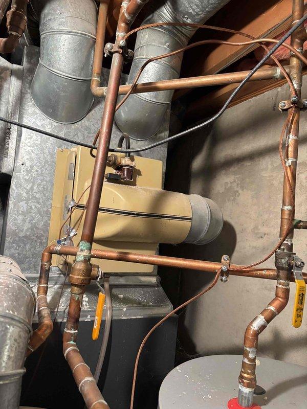 # HP-Heating Problem Service Summary

Responded to a heating system issue on a 7-year-old EnergiAir heat pump unit. Upon diagnostic inspection of the mechanical system, determined that the circuit board had failed and required replacement. Accessed the equipment in the utility space where the unit is installed alongside the existing HVAC ductwork, copper piping, and associated mechanical components. Documented the equipment location and configuration with photographs showing the heat pump integrated with the galvanized ductwork system, expansion tank, and various copper supply lines. Replaced the defective circuit board with manufacturer-specified replacement part to restore proper system operation. Verified all electrical connections were secure and tested the unit through a complete heating cycle to confirm proper functionality. System returned to normal operation with heat pump responding correctly to thermostat calls.