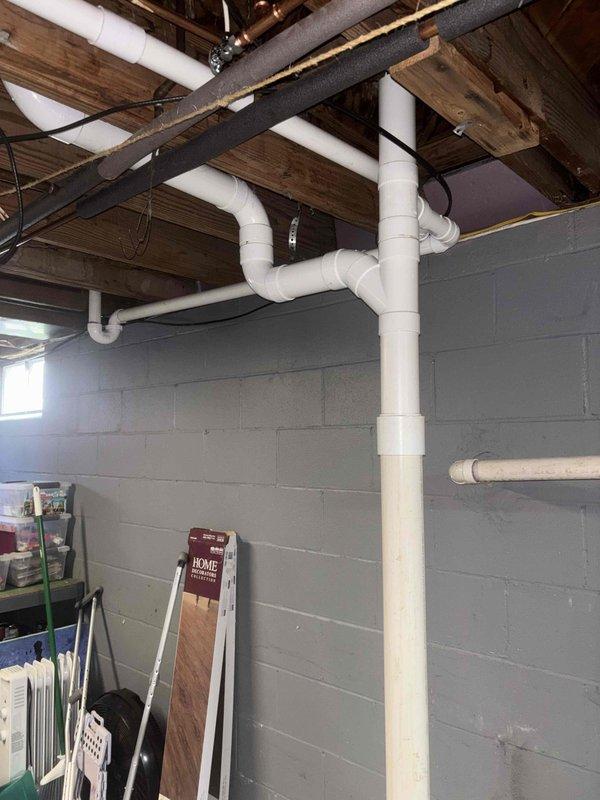 Completed full replacement of main drain stack system from basement level through roof penetration using PVC piping. Installed new vanity drain branch line routing through bottom of vanity cabinet, and replaced existing shower and toilet branch lines with PVC to modernize the drainage system and ensure proper code compliance.