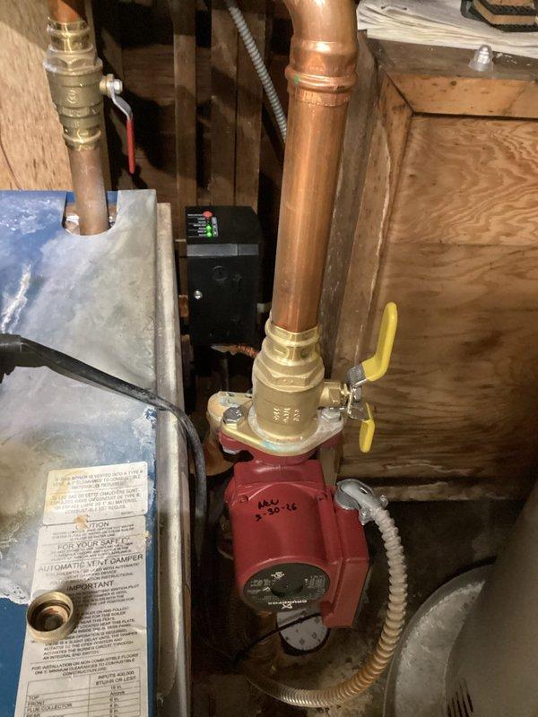 Replaced failed circulator pump on hydronic heating system. Removed heavily corroded pump assembly with deteriorated piping connections showing extensive rust and oxidation damage. Installed new Grundfos circulator pump with proper copper piping connections and brass fittings. Verified proper pump operation and system flow upon completion.