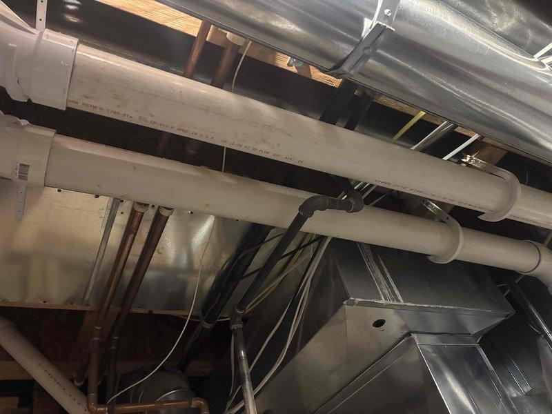 Corrected building code violations identified during mechanical inspection. Replaced non-compliant cellular core PVC vent pipe on furnace exhaust side with proper venting materials per manufacturer installation specifications and M1401.1-2015 MRC requirements. Sealed all joints in newly installed trunk line ductwork and return air drop to meet air sealing standards per M1601.4.1-2015 MRC, ensuring proper system performance and code compliance.