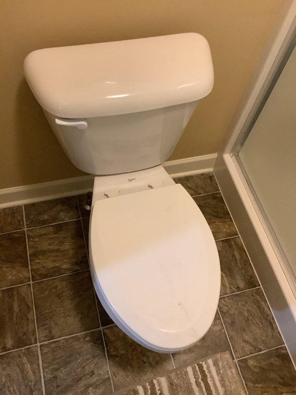 Responded to running toilet issue where fill valve would not shut off due to failed tank-to-bowl gasket. Replaced deteriorated red rubber seal that was no longer creating proper seal, causing continuous water flow. Inspected both toilets in residence per request and confirmed second unit operating properly with no additional repairs needed.