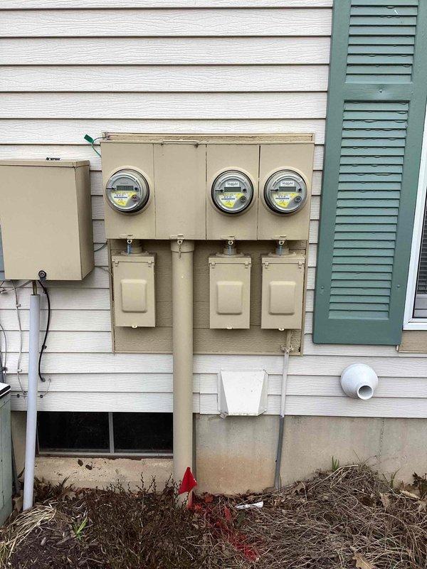 Conducted site assessment for whole-house generator installation at residential condominium property built in 1989. Evaluated existing electrical infrastructure including main service panel located in basement utility area and exterior meter bank configuration with three meters and associated disconnect boxes. Documented current electrical service capacity, panel accessibility, and potential mounting locations for automatic transfer switch. Photographed existing conditions to develop comprehensive installation proposal accounting for integration with 2017 electrical system components and required code-compliant connections for standby power system.