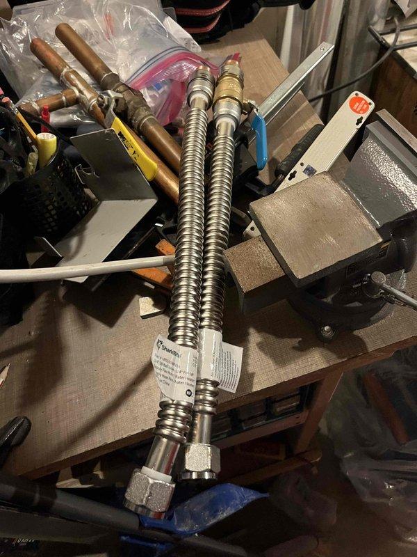 Responded to water leak on newly installed A.O. Smith tank water heater with weakened supply line and suspected gator hook leak. Replaced failed flexible stainless steel braided water supply lines with new compression-fitted hoses. Inspected copper piping connections, brass valves, and all related plumbing fixtures to ensure proper installation and eliminate additional leak sources, restoring system to full operation.