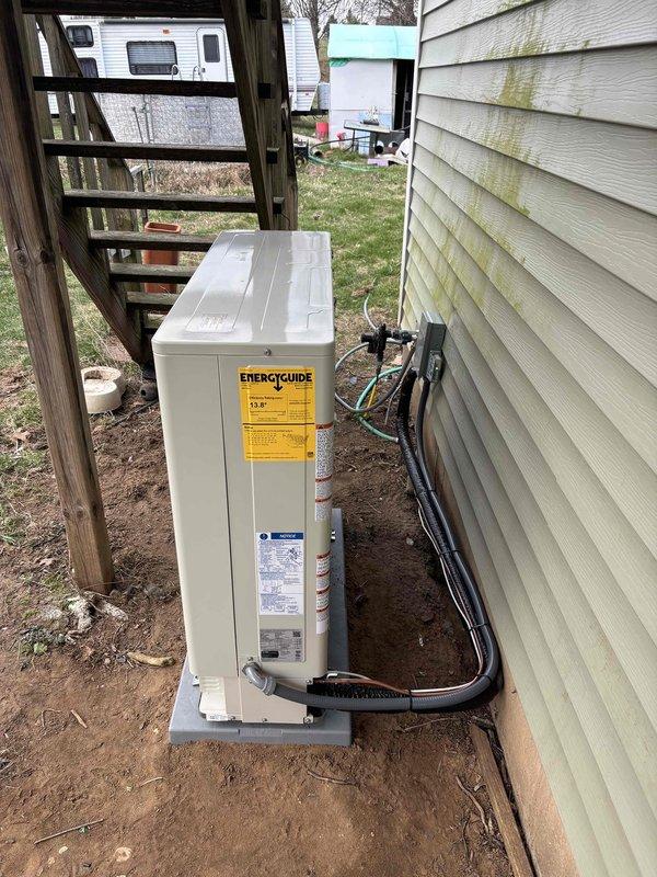 Completed full furnace and air conditioning system installation at residential property. Installed new Amana outdoor condensing units on concrete pad with proper refrigerant line sets, electrical connections, and conduit routing along exterior wall. All equipment mounted, connected, and operational per manufacturer specifications.