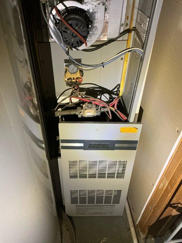 Responded to no-heat call on 36-year-old original furnace with no maintenance history. Upon inspection, diagnosed failed inducer motor causing unit inoperability and strange noises. Furnace has exceeded expected lifespan with all original components intact and is installed in tight clearance configuration adjacent to water heater. Documented equipment condition with photos and advised customer that unit is past its service life expectancy. Recommended replacement over repair due to age and likelihood of additional component failures. Will follow up with repair cost estimate, though replacement is strongly recommended given the advanced age and lack of previous service history.