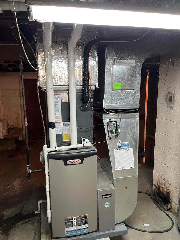Completed full HVAC system installation including Lennox furnace and air handler in basement with associated ductwork, condensate drainage, and electrical connections. Installed outdoor condensing unit on concrete pad with refrigerant line set and electrical conduit routed through exterior wall penetration. All components properly mounted, connected, and tested for operational performance per manufacturer specifications.