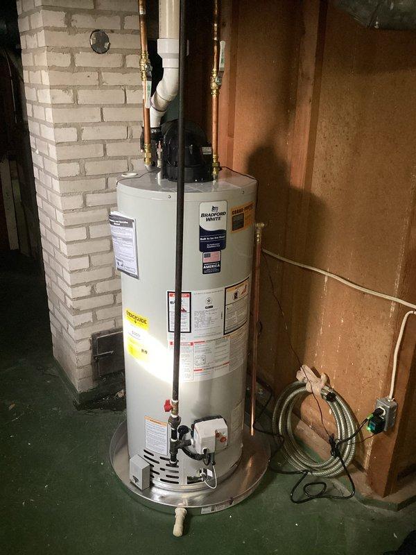 Completed installation of 40-gallon Bradford White power vent natural gas water heater. Installed new copper supply lines with brass shut-off valves, connected gas line with proper shutoff valve, and installed PVC venting system. All connections tested and verified for proper operation with no leaks detected.