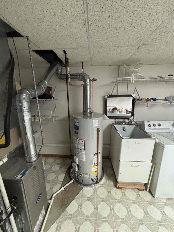 Completed installation of a 40-gallon natural gas water heater (Bradford White model M2X40S6N) in the utility room, replacing the existing unit. Connected all necessary gas lines, water supply lines with shutoff valves, and venting ductwork per manufacturer specifications and code requirements. Verified proper operation, tested for leaks, confirmed appropriate gas pressure settings, and ensured all safety labels and clearance requirements were met.