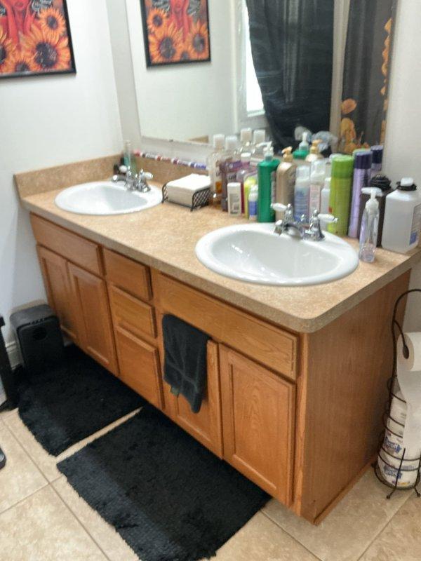 Completed on-site assessment for installation of hot and cold water supply lines to accommodate new washer and dryer hookup. Evaluated existing plumbing infrastructure in bathroom area, documented current fixture configuration including double-sink vanity with existing water supply connections, and photographed work area to determine optimal routing for new appliance water lines. Provided customer with detailed estimate for materials and labor required to extend water supply system to laundry appliance location.