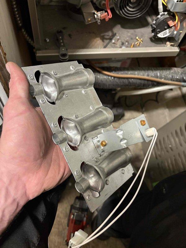 Completed annual heating maintenance on 2-year-old Carrier furnace system. Performed comprehensive tune-up including inspection of gas valve assembly and flame sensor. Removed and examined flame sensor rod, which showed normal wear patterns. Inspected gas valve manifold with electronic controls and verified all electrical connections were secure. System operates without humidifier. All components tested and found functioning within manufacturer specifications.