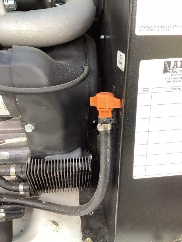 Completed first scheduled maintenance visit on 5-year-old Generac generator unit under recurring service plan. Addressed battery alert indication displayed on control panel. Performed comprehensive inspection of generator components including engine assembly, fuel system, and electrical connections. Verified oil level at dipstick reservoir and inspected condition of all fluid lines and hoses. Checked security of all mounting hardware and connection clamps throughout the unit. Examined fuel shut-off valve operation and associated piping. Inspected engine compartment insulation and ventilation components for proper condition. Documented equipment status with photographic records showing current operational configuration and component conditions. All systems verified functional following inspection protocol.
