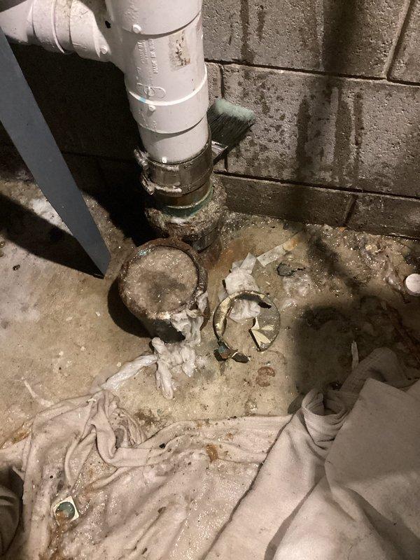 Responded to emergency call for main drain leaking and clogging issue. Upon arrival, found significant water accumulation on basement floor around floor drain and pipe connections, indicating active drainage problem. Inspected plumbing infrastructure including vertical PVC drain line, floor drain assembly, and metal pipe fittings at floor level. Identified compromised drainage system causing water backup and pooling throughout utility area. Removed drop ceiling tile to access overhead plumbing connections and assess extent of leak. Cleared main drain blockage and addressed leaking connections at floor level. Verified proper water flow through drainage system and confirmed resolution of backup issue. Cleaned work area and restored access panel.