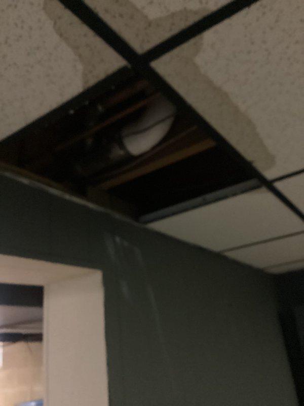 Responded to emergency call for main drain leaking and clogging issue. Upon arrival, found significant water accumulation on basement floor around floor drain and pipe connections, indicating active drainage problem. Inspected plumbing infrastructure including vertical PVC drain line, floor drain assembly, and metal pipe fittings at floor level. Identified compromised drainage system causing water backup and pooling throughout utility area. Removed drop ceiling tile to access overhead plumbing connections and assess extent of leak. Cleared main drain blockage and addressed leaking connections at floor level. Verified proper water flow through drainage system and confirmed resolution of backup issue. Cleaned work area and restored access panel.