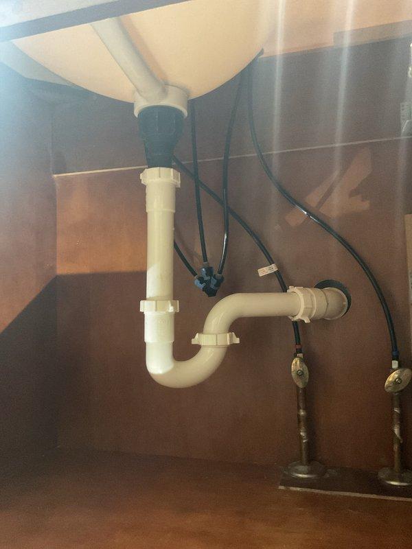 Responded to plumbing drain issue where newly installed faucet assembly included drain pipe with reduced diameter compared to existing P-trap connection. Installed appropriate transition fitting to connect the smaller drain tailpiece to the standard-size P-trap assembly, ensuring proper seal and drainage function. Verified all connections were secure with no leaks and system operating correctly.