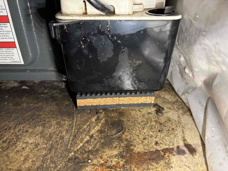 Completed annual heating maintenance on an 18-year-old Goodman furnace system without humidifier. Performed comprehensive tune-up including inspection of all mechanical components, burner assembly, heat exchanger, blower motor, and electrical connections. Noted moisture accumulation in drain pan and condensation on unit exterior, with visible water staining on base surface indicating ongoing drainage conditions. All safety controls tested and verified operational, system cycling properly with no immediate concerns identified.