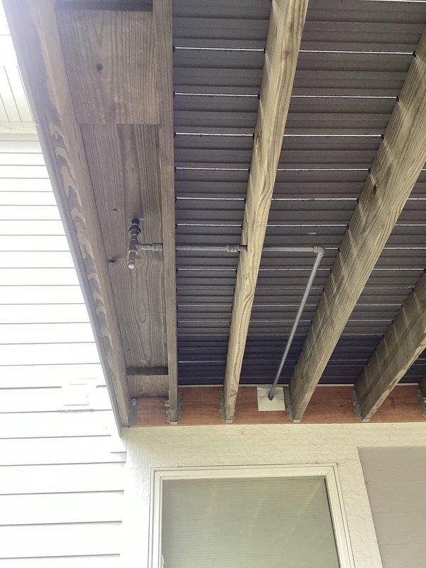 Returned to property to complete re-installation of gas line on covered porch for outdoor grill connection. Gas line was properly routed along ceiling support beams and secured with appropriate mounting hardware. Installation completed as scheduled with all work performed in accordance with local gas fitting codes and safety standards.