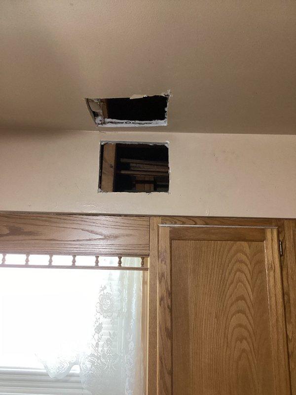 Responded to callback for persistent kitchen sink leak. Upon arrival, conducted thorough inspection of previously repaired plumbing connections. Investigation required accessing crawl space beneath kitchen area to identify source of ongoing water intrusion. Cut access openings in ceiling and wall drywall to expose plumbing lines and structural components. Inspection revealed leak originating from supply lines or drain connections above crawl space. Documented conditions with photos showing exposed floor joists, insulation, and structural framing. Access points created will allow for proper repair of leaking plumbing components and subsequent restoration of drywall surfaces.