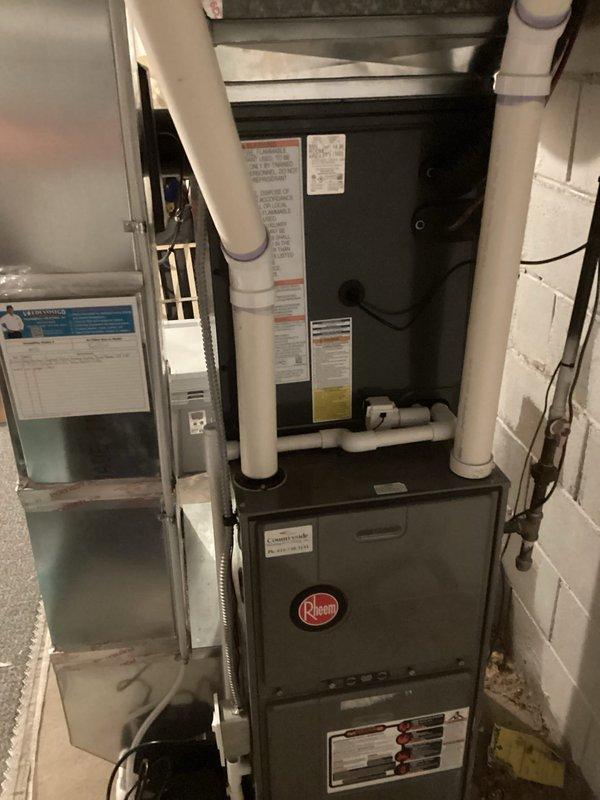 Completed full ACREP-AC installation including Rheem furnace and air handler in basement mechanical room with associated condensate drain lines and PVC venting. Installed outdoor condensing unit on concrete pad with refrigerant line set, electrical disconnect box, and all required connections. System tested and verified operational with all manufacturer labels and safety documentation properly affixed.