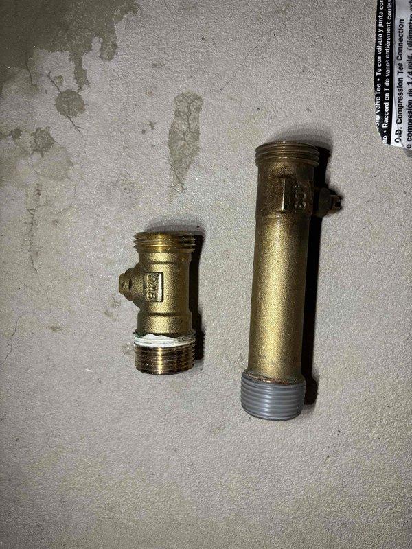 Installed whole home humidifier system with all necessary plumbing connections and fittings. Brass T-fitting and pipe nipple were properly installed and connected to water supply line at water heater location to provide water source for humidifier operation. Installation completed with proper mounting, electrical connections, and water line routing per manufacturer specifications.