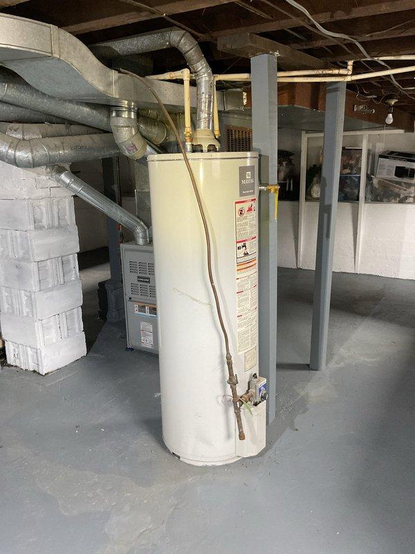 Responded to no hot water complaint at residential property. Upon inspection, found water heater over 10 years old with significant corrosion visible on connecting pipes and fittings. Documented existing conditions including corroded piping sections showing greenish-brown patina buildup and deteriorated connections. Customer elected to enroll in club membership and proceeded with replacement of one furnace and one air conditioning unit in addition to addressing the water heater concern.