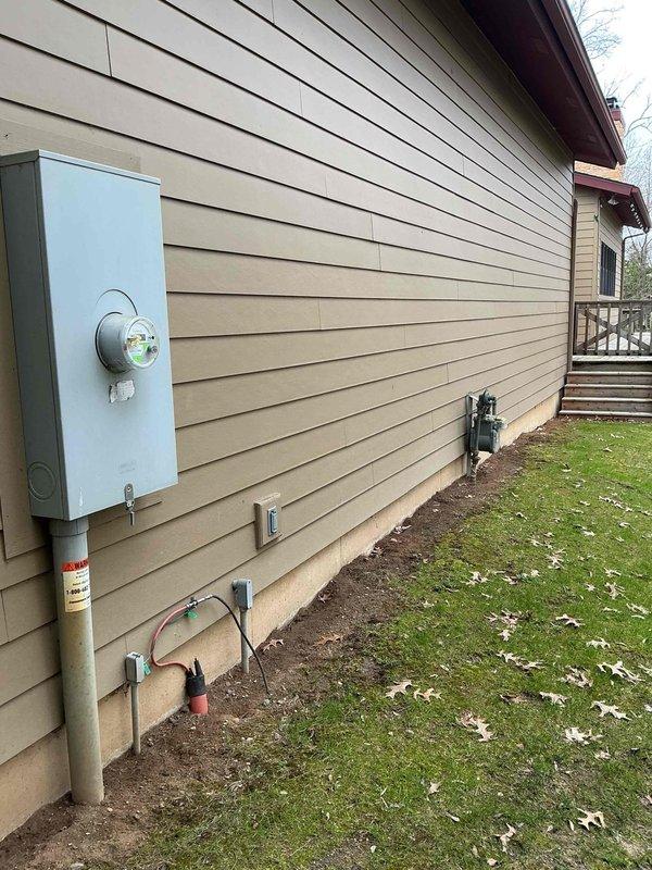 Responded to electrical service call for multiple fixture issues and surge protection evaluation. Inspected vanity light fixtures, ceiling fan operation, and malfunctioning light switch as requested. Documented existing electrical meter installation and exterior service panel configuration. Meter displayed proper utility connection with digital interval recording capabilities and standard residential service specifications. External electrical components showed typical weathering consistent with outdoor exposure. Assessed overall electrical system condition and provided recommendations for fixture replacements and whole-house surge protection options to enhance electrical safety and system reliability.