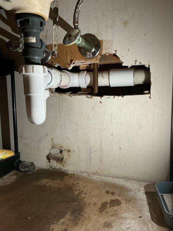 Responded to plumbing leak service call to inspect water heater and bathroom sink. Inspected water heater installation including top connections, pressure relief valve, and supply lines for proper operation and signs of deterioration. Examined anode rod condition to assess tank corrosion protection. Investigated bathroom sink leak, inspecting P-trap assembly, drain connections, garbage disposal mounting, and supply line fittings. Identified source of slow leak at sink drain connections. Tightened drain fittings and verified proper seal on P-trap. Confirmed water heater components functioning properly with no immediate concerns noted. Tested all connections for leaks and verified proper drainage. System operating as intended upon completion.