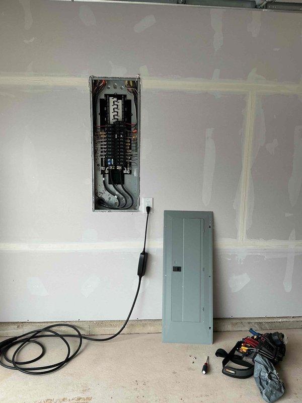Conducted electrical estimate for installation of NEMA 14-50 outlet for electric vehicle charging adjacent to existing breaker panel. Assessed interior electrical panel location, verified adequate circuit capacity, and evaluated exterior meter and service disconnect configuration to determine feasibility and material requirements for dedicated 240V charging circuit.