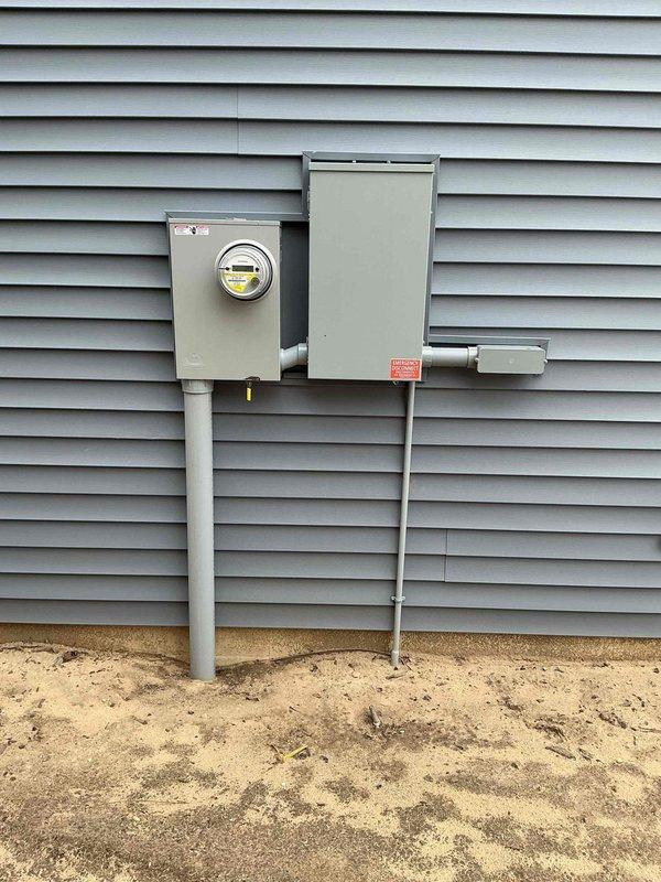 Conducted electrical estimate for installation of NEMA 14-50 outlet for electric vehicle charging adjacent to existing breaker panel. Assessed interior electrical panel location, verified adequate circuit capacity, and evaluated exterior meter and service disconnect configuration to determine feasibility and material requirements for dedicated 240V charging circuit.