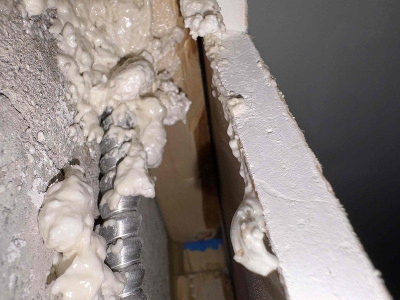 Completed inspector-required corrections by removing the upper portion of drywall to expose electrical wiring in floor joist area. Installed metal nail plates over all exposed Romex wiring to provide code-compliant protection against future penetration, ensuring all electrical cables running through framing members meet current safety standards for reinspection approval.