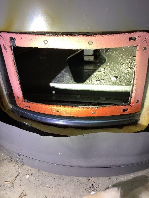 Responded to emergency service call for 6-year-old Rheem water heater not heating properly. Upon arrival, confirmed thermopile was displaying two red indicator lights, indicating low voltage output below operational threshold. Performed diagnostic testing of gas control valve and thermopile assembly. Inspected burner chamber and pilot assembly for proper operation and flame characteristics. Accessed internal components through service panel, noting accumulated debris in combustion chamber area. Verified proper venting and air flow through the unit. Tested thermopile voltage output and determined replacement necessary to restore proper heating function. Documented equipment condition with photographs showing internal cabinet components, access panel with visible corrosion on frame, and debris accumulation requiring cleaning. Provided recommendations for thermopile replacement to restore unit to full operational status.