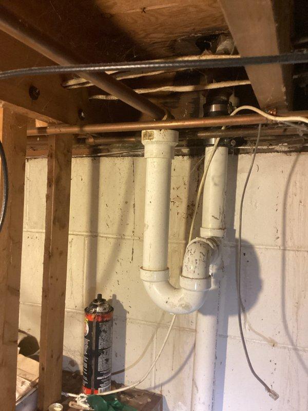 Conducted on-site assessment for relocating washer and dryer connections from existing location to alternate room within residence. Evaluated current plumbing infrastructure in basement area, including existing PVC drainage system and supply line routing along concrete block foundation walls. Inspected kitchen sink plumbing for reported potential leak, examining connections and drainage components accessible from basement crawl space. Documented existing conditions through photography to support estimate preparation for proposed relocation work and any necessary leak remediation.