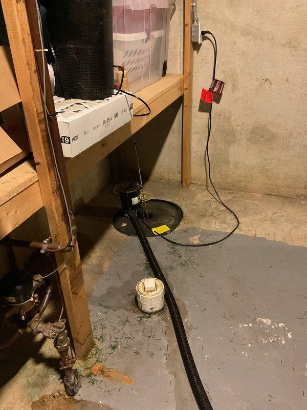 Conducted on-site evaluation of existing sump pump system in basement utility area for replacement estimate. Assessed current pump configuration, discharge piping, electrical connections, and drainage routing to determine scope of replacement work and equipment specifications needed for proper water management system installation.