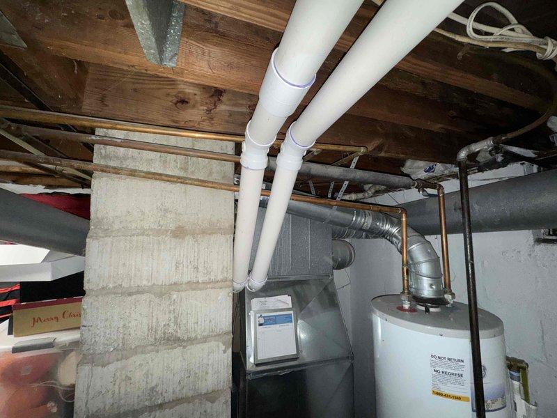 Assessed existing 16-year-old 40-gallon GE water heater installed in 2010 for replacement. Documented current installation including copper supply piping, brass connections, shut-off valves, and venting configuration in basement mechanical room. Provided pricing estimates for complete installation of new 40-gallon and 50-gallon replacement units, as well as labor-only pricing option for customer-supplied equipment.