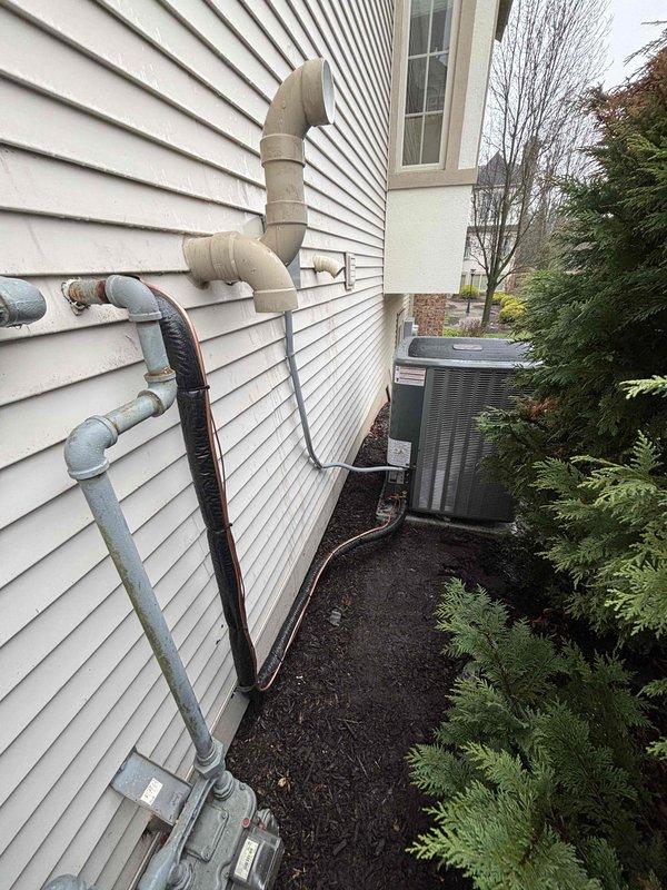 Completed full HVAC system replacement including furnace and air conditioning condenser unit. Installed new furnace in basement mechanical room on equipment platform with proper venting system consisting of PVC exhaust and intake piping routed through ceiling and exterior wall. Mounted new outdoor condenser unit on grade with mulch base, connected refrigerant lines, and installed condensate drain lines along exterior siding. Verified all electrical connections at panel, tested system operation, and confirmed proper airflow and temperature differential. All equipment installed per manufacturer specifications and local code requirements.