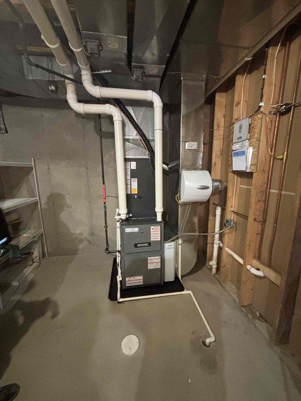 Completed full HVAC system replacement including furnace and air conditioning condenser unit. Installed new furnace in basement mechanical room on equipment platform with proper venting system consisting of PVC exhaust and intake piping routed through ceiling and exterior wall. Mounted new outdoor condenser unit on grade with mulch base, connected refrigerant lines, and installed condensate drain lines along exterior siding. Verified all electrical connections at panel, tested system operation, and confirmed proper airflow and temperature differential. All equipment installed per manufacturer specifications and local code requirements.