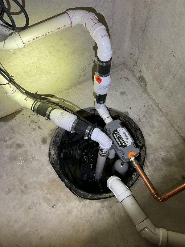 Responded to water backup emergency and installed comprehensive sump pump system with backup protection. Installation included new primary sump pump in basin with dual discharge configuration utilizing PVC and copper piping, complete with check valves, isolation valves, and proper venting. Integrated system with existing plumbing infrastructure, securing all components to concrete foundation wall with appropriate mounting hardware and ensuring proper drainage flow to prevent future basement flooding.