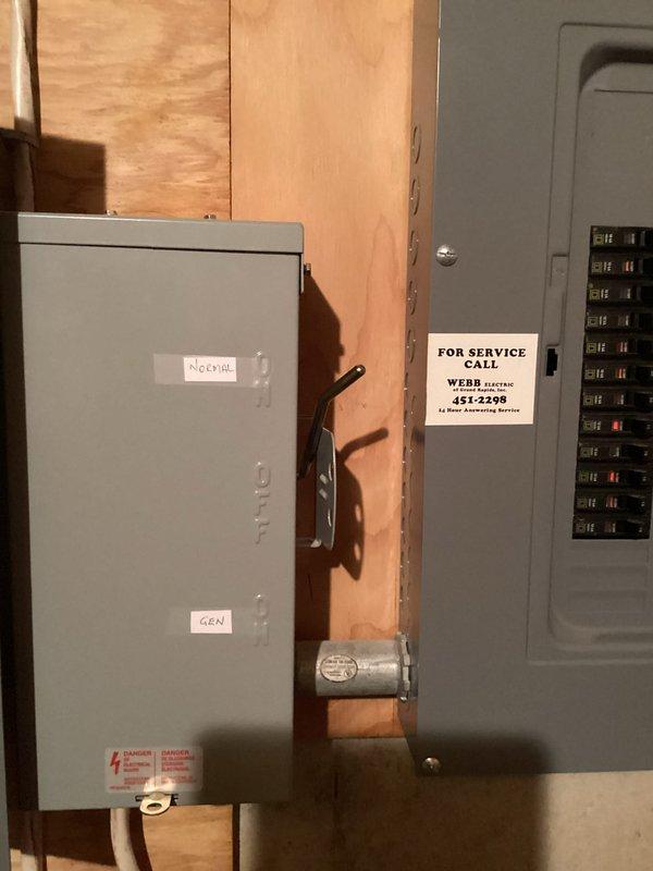 Conducted site assessment for whole-home Generac generator installation at residential property. Evaluated existing electrical infrastructure including two main service panels mounted in basement utility area. Documented current electrical configuration with dual panel setup featuring dedicated generator disconnect switch already labeled "GEN" and main breaker panel with multiple circuits. Assessed available space and clearances in basement area for potential generator transfer switch installation. Reviewed electrical service capacity and panel condition to determine compatibility with automatic standby generator system. Photographed electrical panels, service disconnect, existing conduit pathways, and surrounding utility area to document installation requirements and identify any potential obstacles. Evaluated access points for natural gas or propane fuel line connection and exhaust venting requirements. Determined optimal placement for exterior generator pad and unit positioning rela