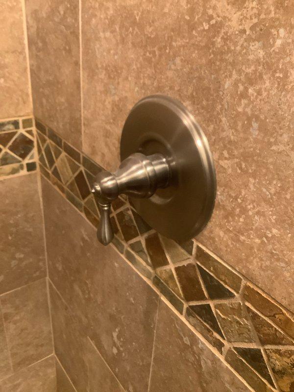 Responded to service call for multiple plumbing issues including inadequate hot water delivery at shower, dripping bathroom faucet, and leaking outdoor spigot. Inspected shower control valve and cartridge assembly, adjusted temperature limiting stop to increase hot water flow, and verified proper operation of mixing valve. Replaced worn washers and seals on bathroom faucet to eliminate drip. Repaired outdoor hose bib by replacing packing nut and stem washer to stop exterior leak. All fixtures tested and confirmed operational upon completion.