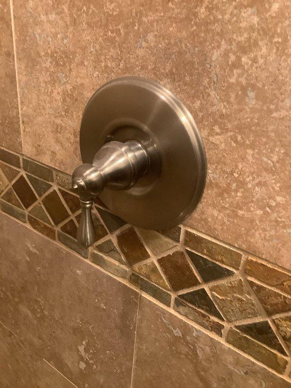 Responded to service call for multiple plumbing issues including inadequate hot water delivery at shower, dripping bathroom faucet, and leaking outdoor spigot. Inspected shower control valve and cartridge assembly, adjusted temperature limiting stop to increase hot water flow, and verified proper operation of mixing valve. Replaced worn washers and seals on bathroom faucet to eliminate drip. Repaired outdoor hose bib by replacing packing nut and stem washer to stop exterior leak. All fixtures tested and confirmed operational upon completion.