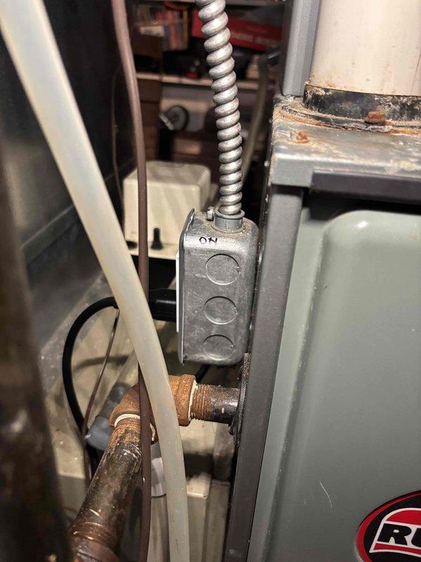 Responded to water leak service call for 15-year-old furnace condensation pump. Upon inspection, confirmed pump was actively leaking while heating system remained operational. Documented existing conditions showing significant corrosion on copper fittings and water staining on concrete floor around pump unit. Photographed condensate pump assembly, associated plumbing connections, and orange PVC discharge piping for service records. Given the age of the pump and active leak condition, recommended pump replacement to prevent further water damage and ensure reliable condensate removal from furnace operation.