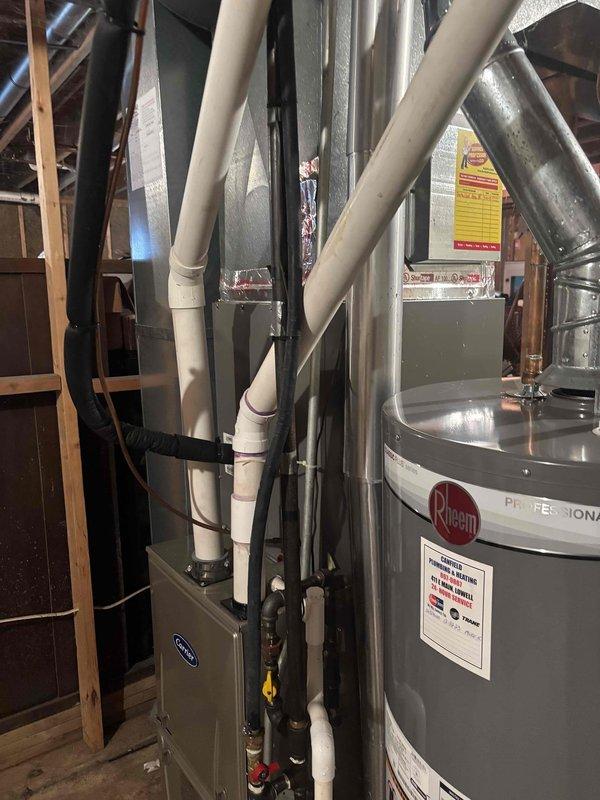 Completed annual cooling maintenance on 8-year-old Lennox system originally installed in 2017. Performed comprehensive tune-up inspection of air handler unit, verified proper operation of all components, and documented equipment conditions with photos of mechanical room showing HVAC system, associated plumbing connections, and water heater installation. System operating within normal parameters with no immediate concerns identified.