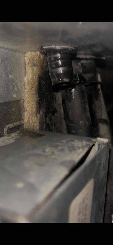 Responded to water leak complaint near furnace following recent AC installation. Upon arrival, inspected the area and discovered significant water staining and moisture accumulation on concrete floor surrounding the HVAC equipment. Traced the source of the leak to condensate drainage issue related to the newly installed air conditioning system. Examined the evaporator coil assembly, drain pan, and condensate line connections. Found that the condensate drain line was not properly secured and draining correctly, causing water to overflow onto the floor. Repositioned and secured the condensate line, verified proper pitch for drainage, and tested the system operation. Confirmed condensate was flowing properly through the drain line without leakage. Cleaned up accessible water residue and advised that existing concrete staining would require time to dry completely. System tested and operating within normal parameters with no further leakage observed.