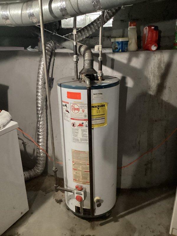 Responded to service call for leaking interior tank on 36-year-old conventional water heater. Conducted on-site assessment of existing unit showing signs of tank failure and documented current installation configuration including venting, piping connections, and utility room layout. Provided consultation regarding tankless water heater replacement options, discussing system specifications, installation requirements, and energy efficiency considerations for the residential application.
