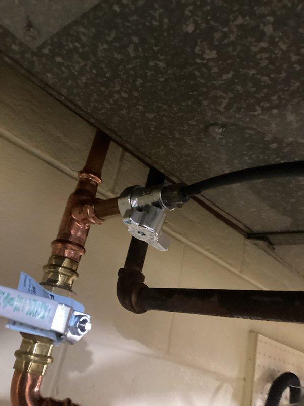 # Plumbing Leak Repair

Responded to a plumbing leak issue and performed comprehensive inspection of water supply lines and shut-off valve assembly. Located active leak at copper pipe compression fitting connection beneath sink fixture. Tightened compression fittings on copper supply line and replaced faulty angle stop valve with new chrome-finished shut-off valve to eliminate leak. Verified all connections were secure and tested system under full water pressure to confirm leak was resolved. Inspected adjacent black supply lines and electrical conduit for any secondary issues. Applied proper torque to all fittings and ensured no water seepage at valve connections. System restored to full operational status with no active leaks detected upon completion.