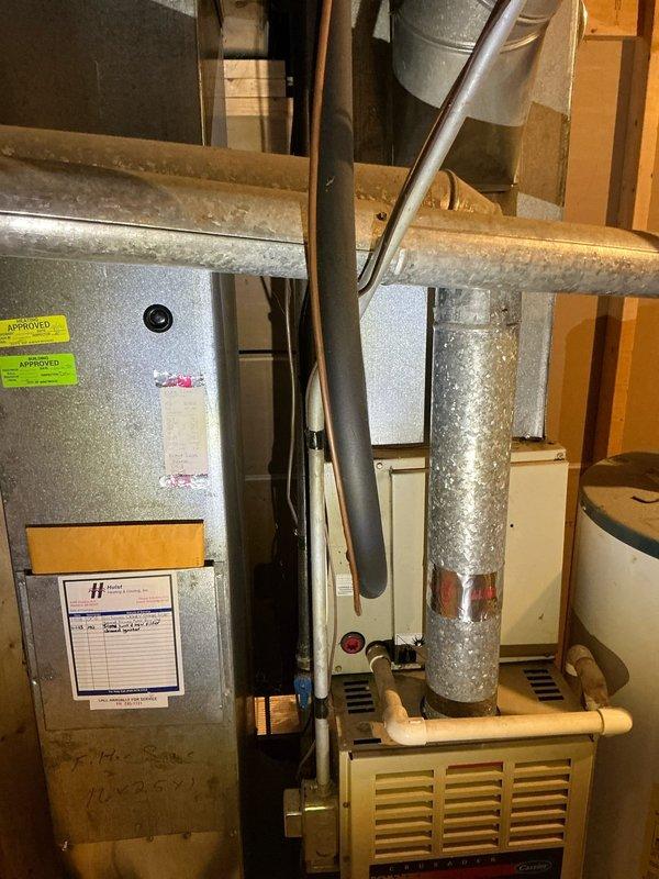 Performed comprehensive diagnostic evaluation of residential air conditioning system experiencing persistent freezing issues despite recent repairs. Inspected air handler, furnace unit, ductwork configuration, and condensate drainage system in basement installation. Documented existing HVAC equipment setup including vertical duct runs with visible moisture accumulation and flexible duct connections throughout the space. Provided detailed estimate for necessary repairs to resolve ongoing freeze-up condition and restore proper system operation.