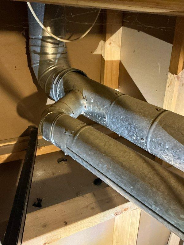 Performed comprehensive diagnostic evaluation of residential air conditioning system experiencing persistent freezing issues despite recent repairs. Inspected air handler, furnace unit, ductwork configuration, and condensate drainage system in basement installation. Documented existing HVAC equipment setup including vertical duct runs with visible moisture accumulation and flexible duct connections throughout the space. Provided detailed estimate for necessary repairs to resolve ongoing freeze-up condition and restore proper system operation.