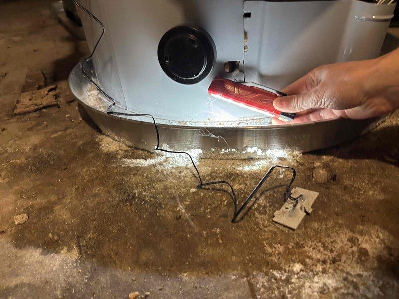Responded to service call for 7-year-old water heater producing lukewarm water with reduced heating performance. Performed diagnostic inspection and tune-up service on unit. Inspected tank condition, heating elements, thermostat settings, and plumbing connections. Noted visible corrosion on threaded pipe connections and brass fittings, typical of unit age. Verified no active leaks present. Documented equipment condition with photos showing corroded pipe threading, tank mounting, and floor area beneath unit. Adjusted system settings as needed to restore proper water temperature output.